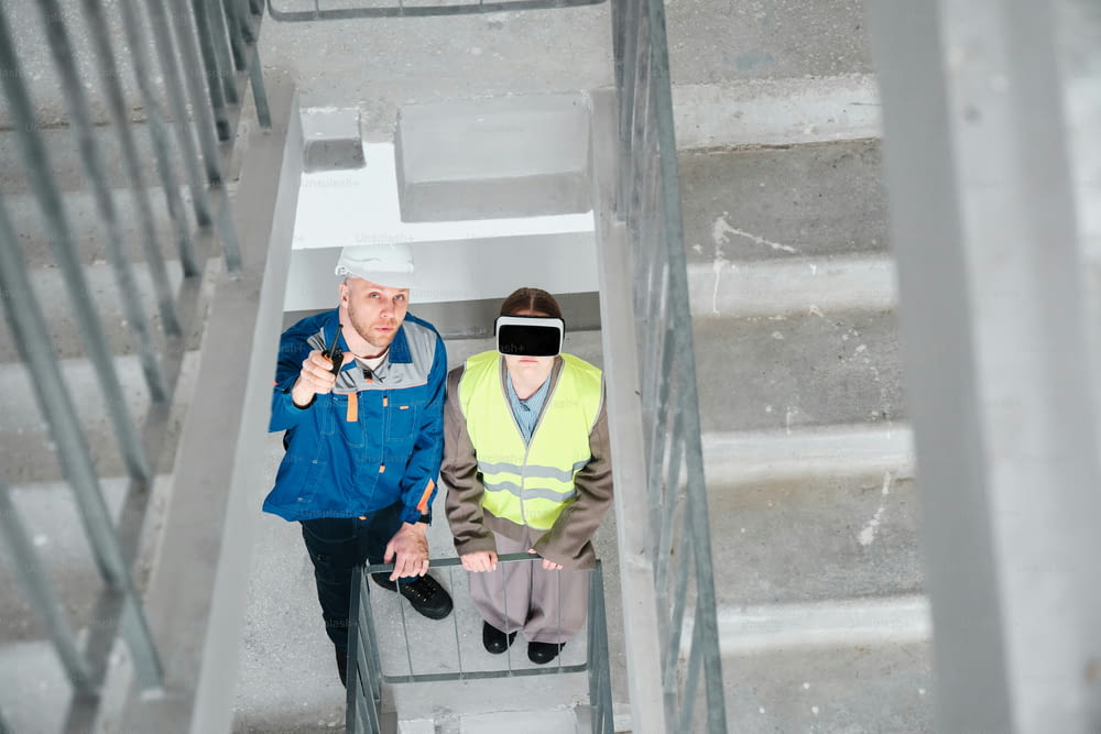a man and a woman walking up a flight of stairs