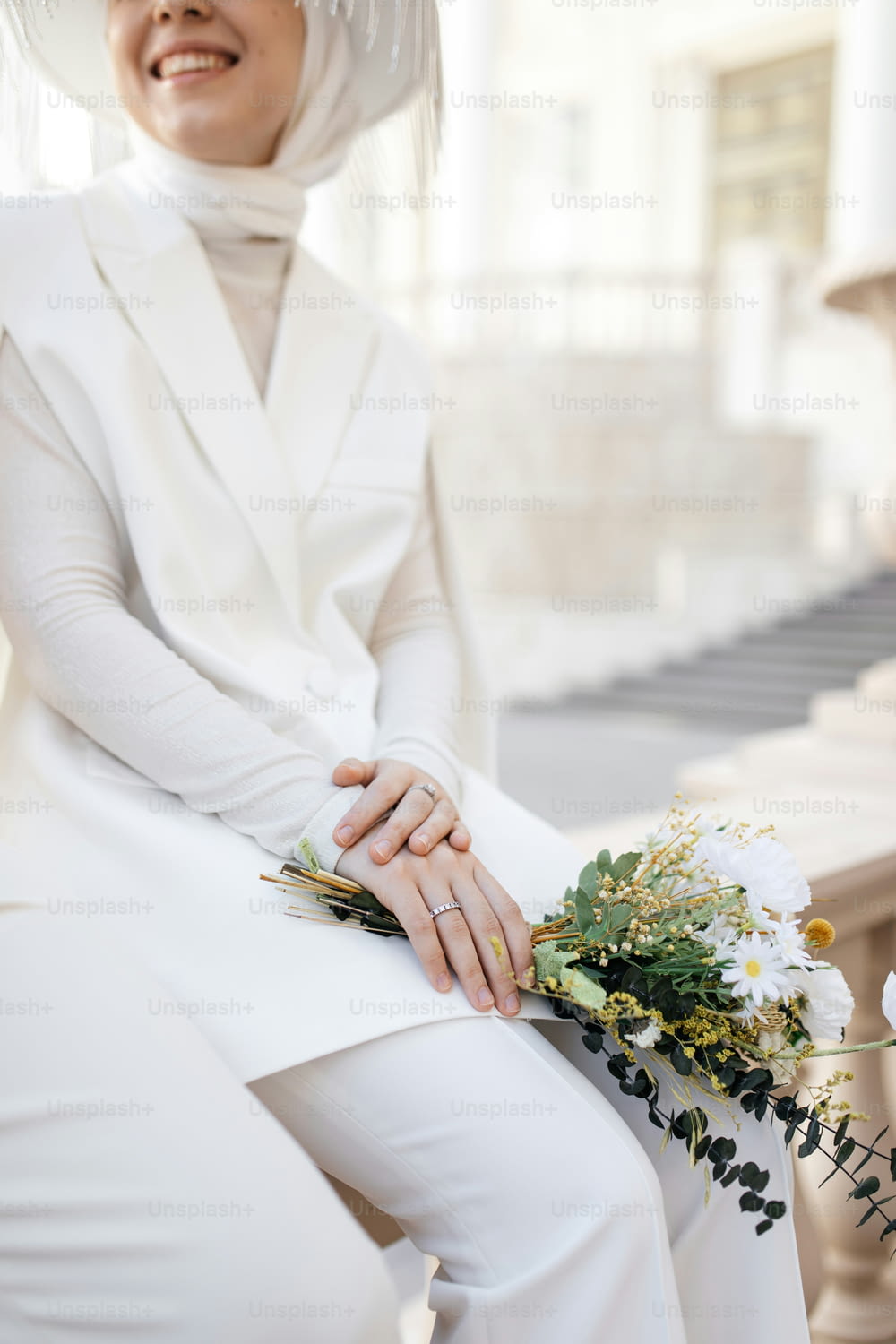 a woman in a white outfit and a bouquet of flowers