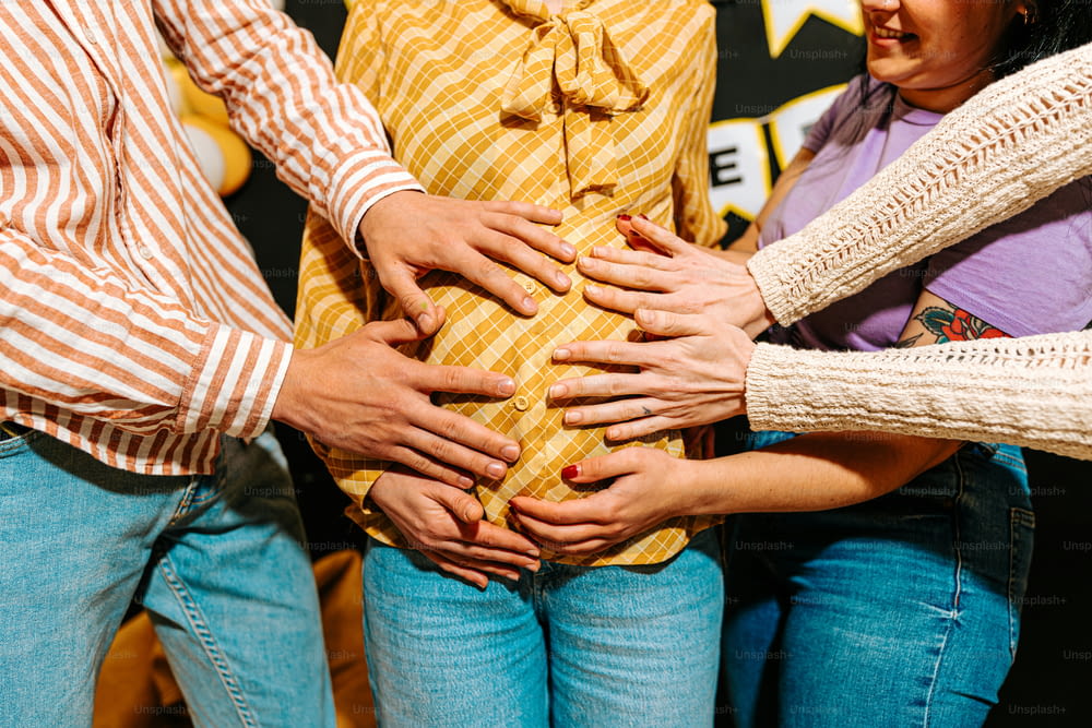 a group of people putting their hands together