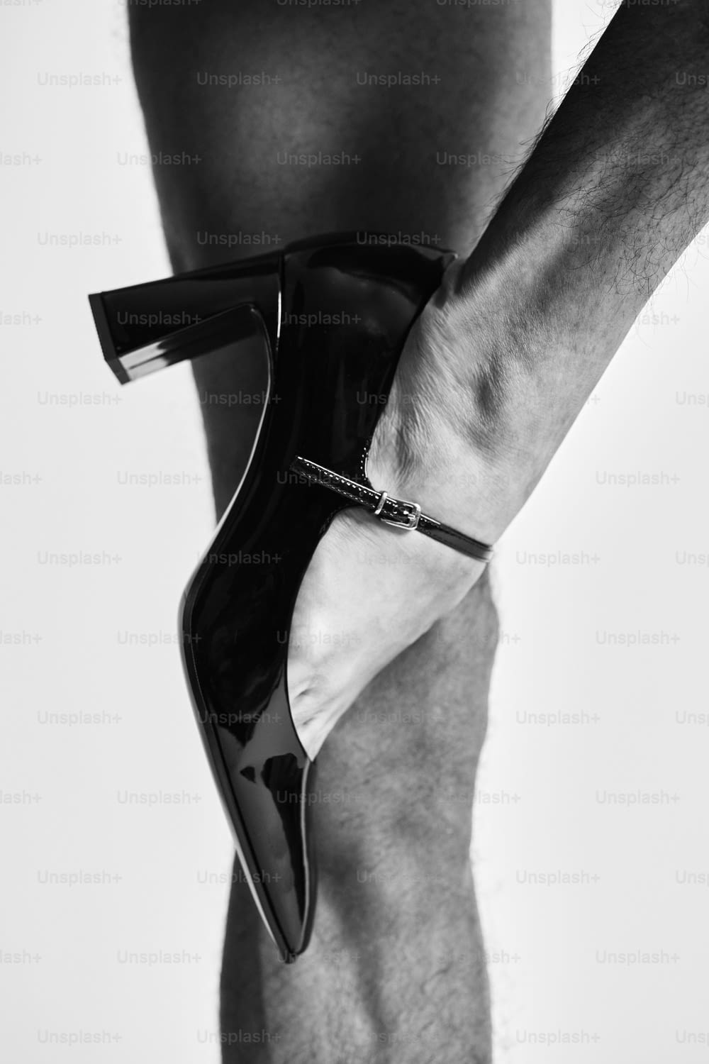 a man's legs with a pair of high heels