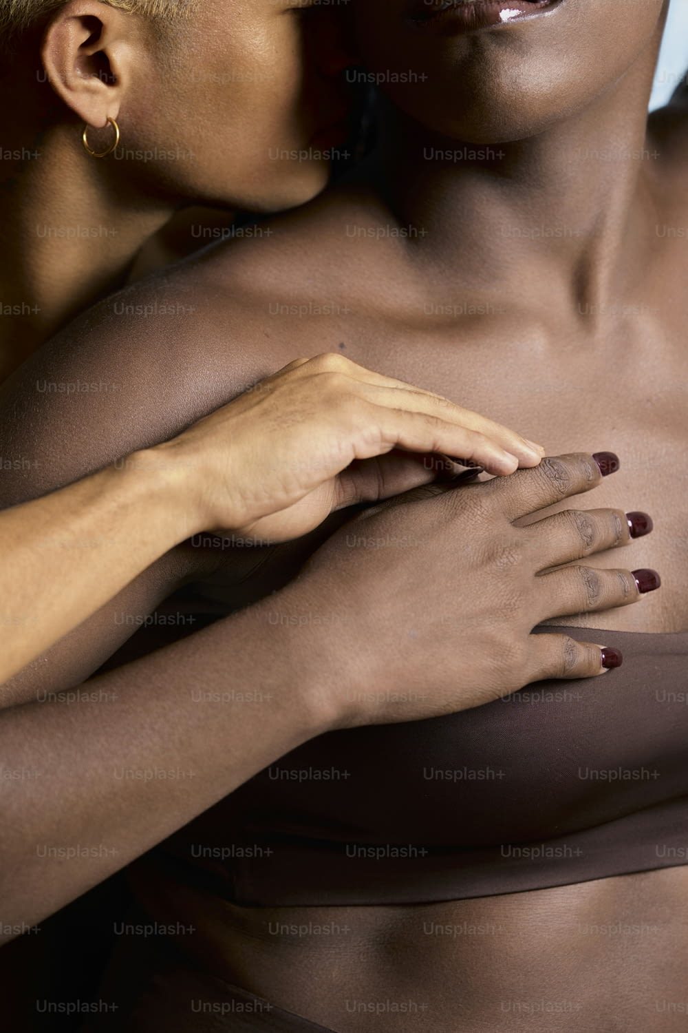 a close up of a woman with her hands on her chest