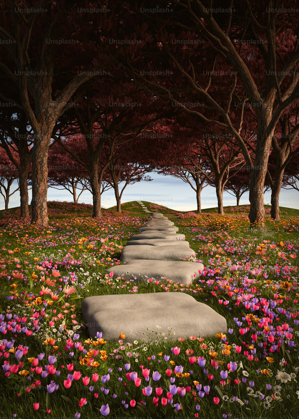 a stone path surrounded by flowers and trees