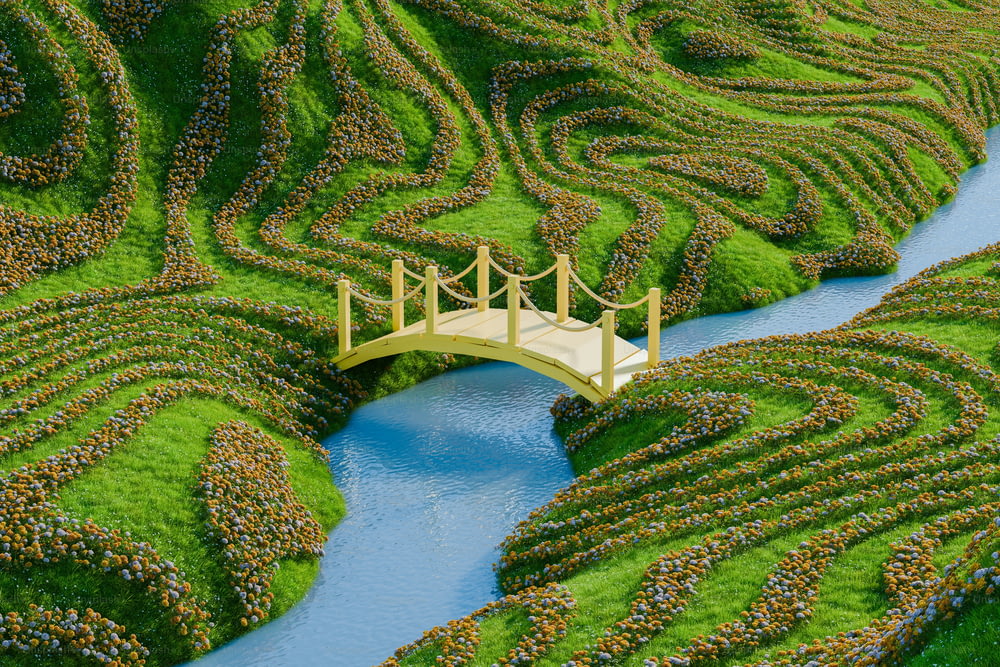 a bridge over a river surrounded by a lush green field