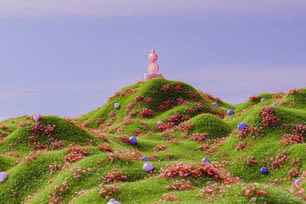 a hill covered in green grass and pink flowers