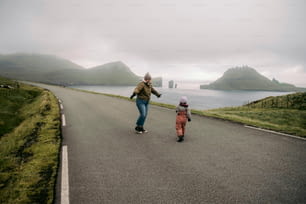 a person riding a skateboard next to a small child