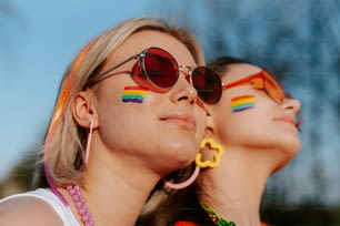 two women with rainbow painted on their faces