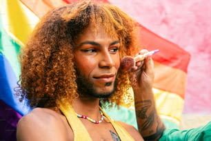 a man with long curly hair holding a cigarette
