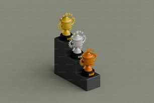 um conjunto de três troféus sentados um em cima do outro