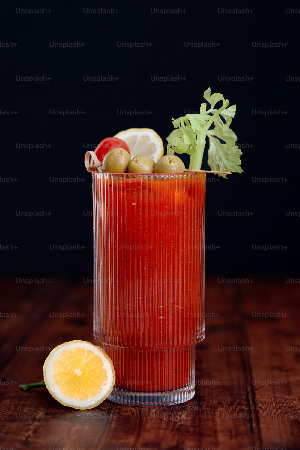 a bloody drink with garnishes and garnishes in a glass