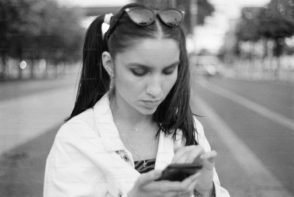 a young woman looking at her cell phone