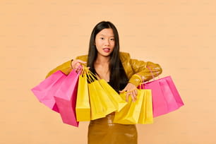 a woman holding two shopping bags in her hands