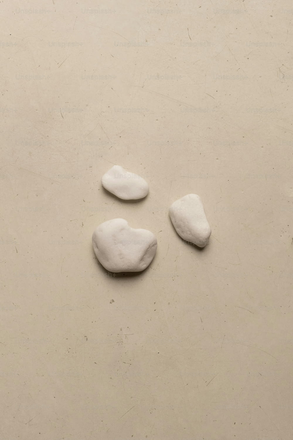 three white rocks sitting on top of a table