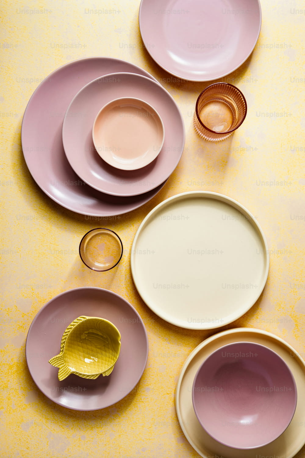 uma mesa coberta com lotes de pratos de cores diferentes