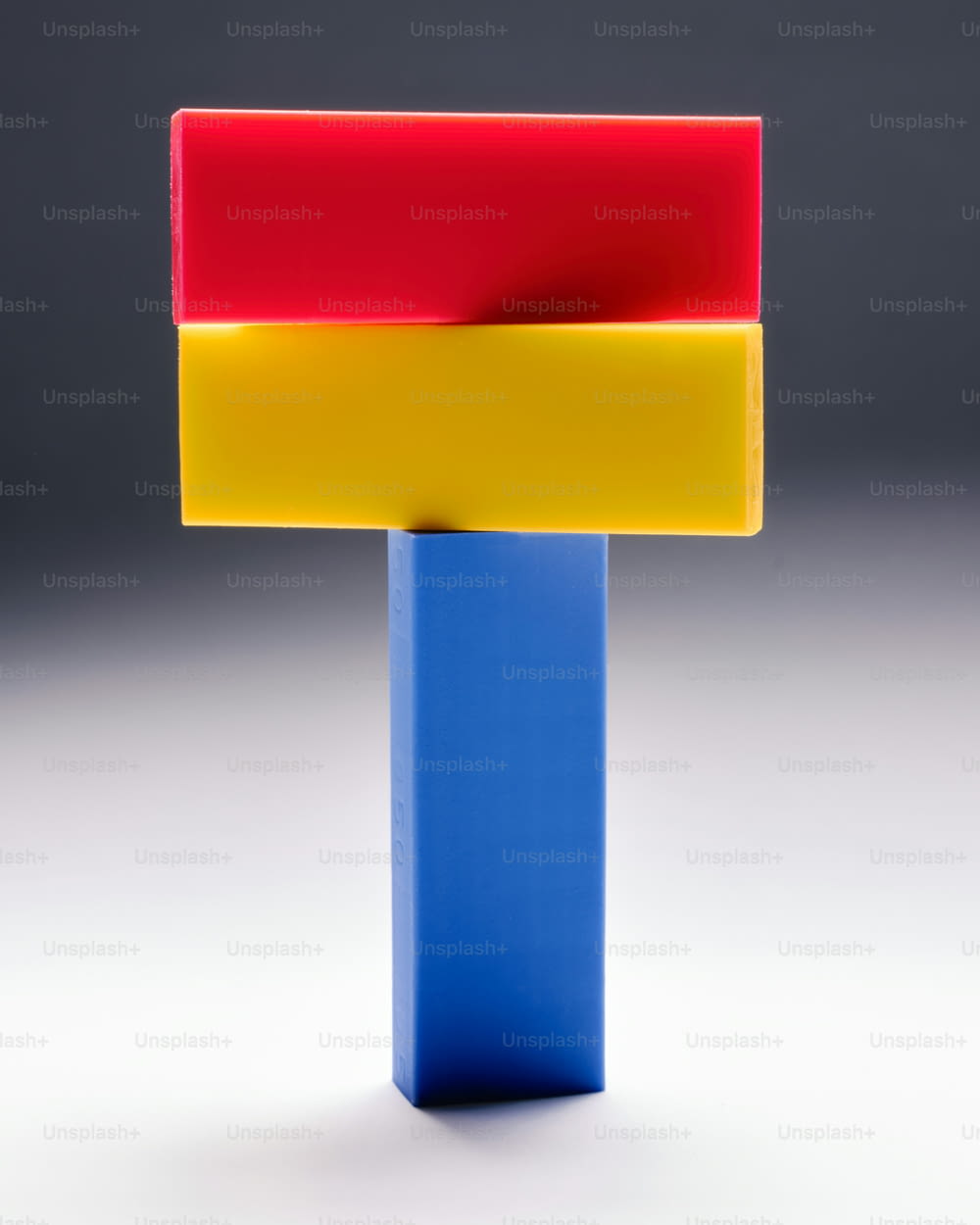 a blue, yellow, red, and orange object on a white background
